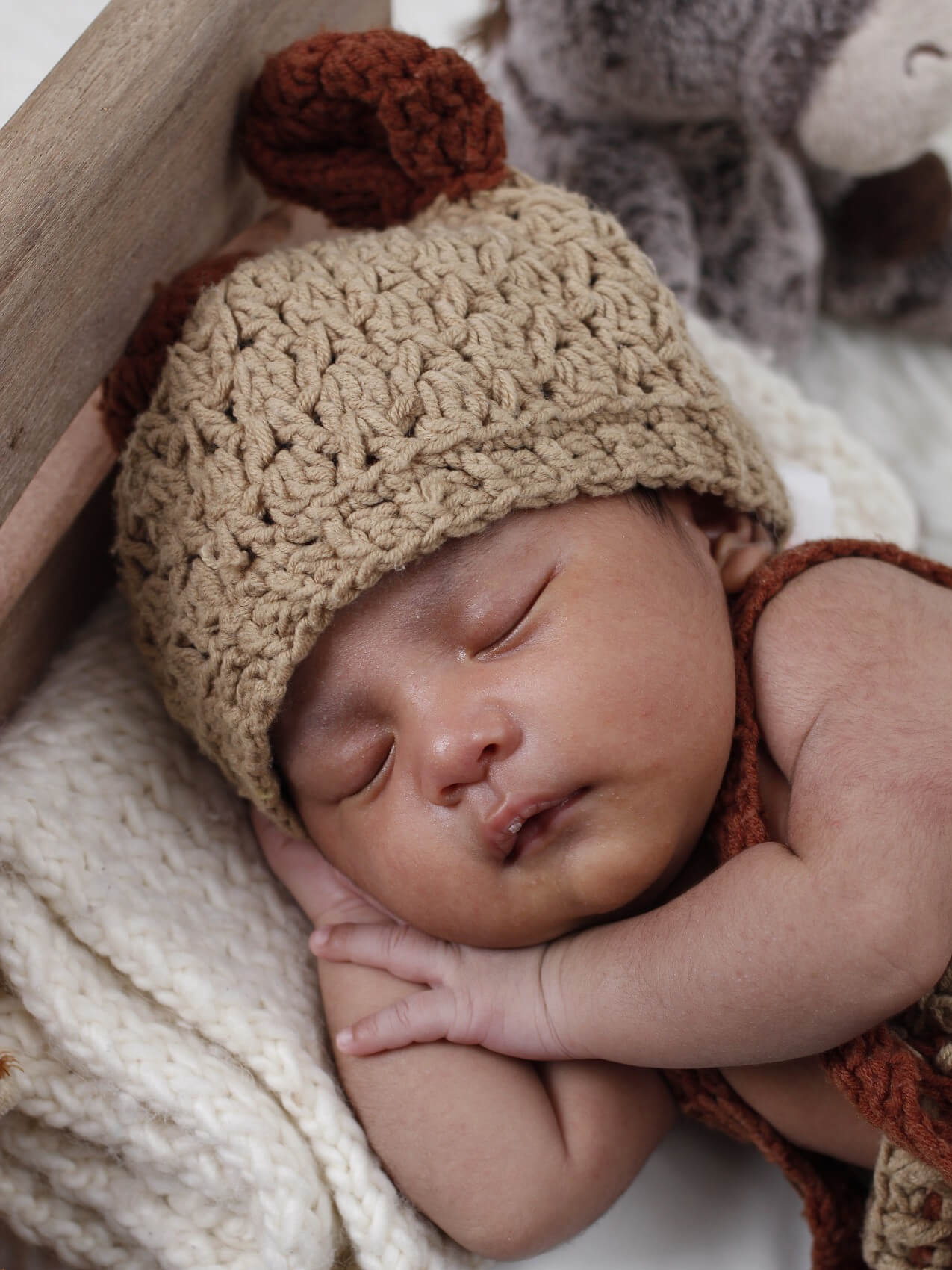 A baby is sleeping with a beanie
